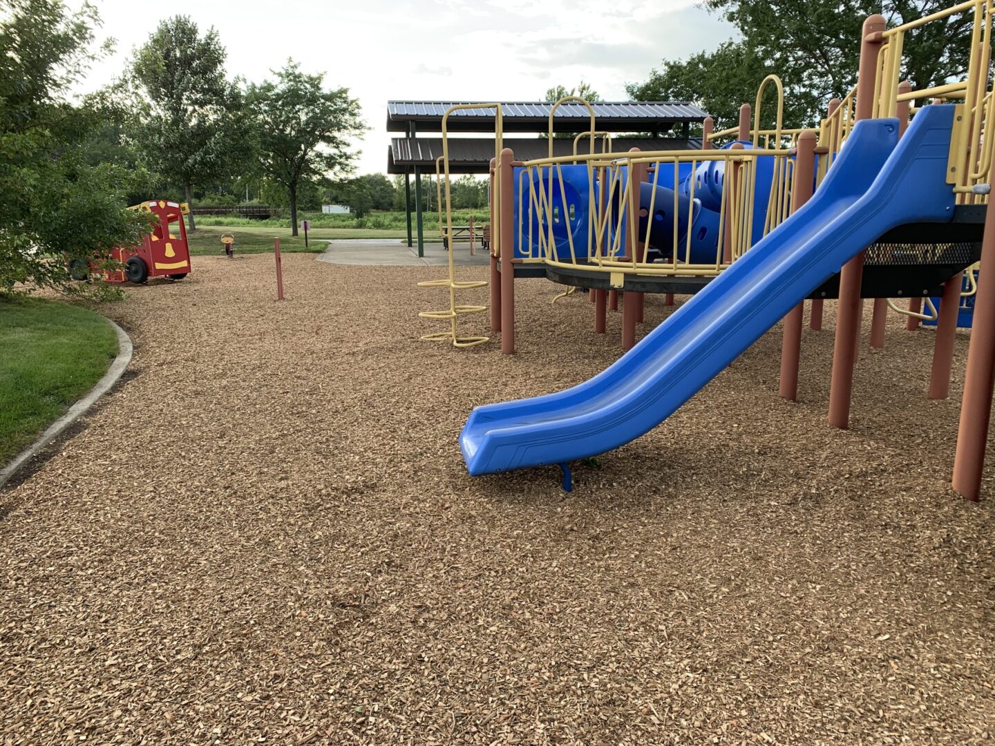 A playground with a blue slide