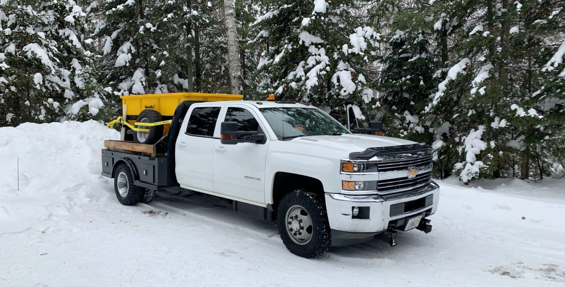 snow on road and a pick up truck